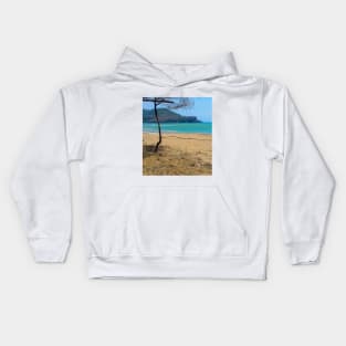 White sand beach with pine tree trunks and mountain in backround Kids Hoodie